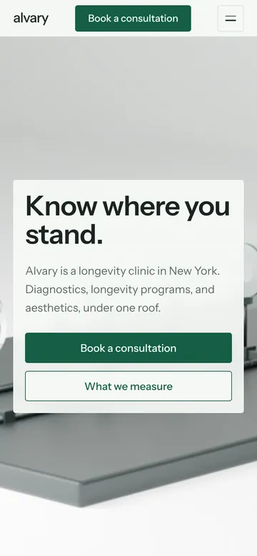 The Alvary hero on a phone, the Know where you stand headline over the optical bench in near-white space