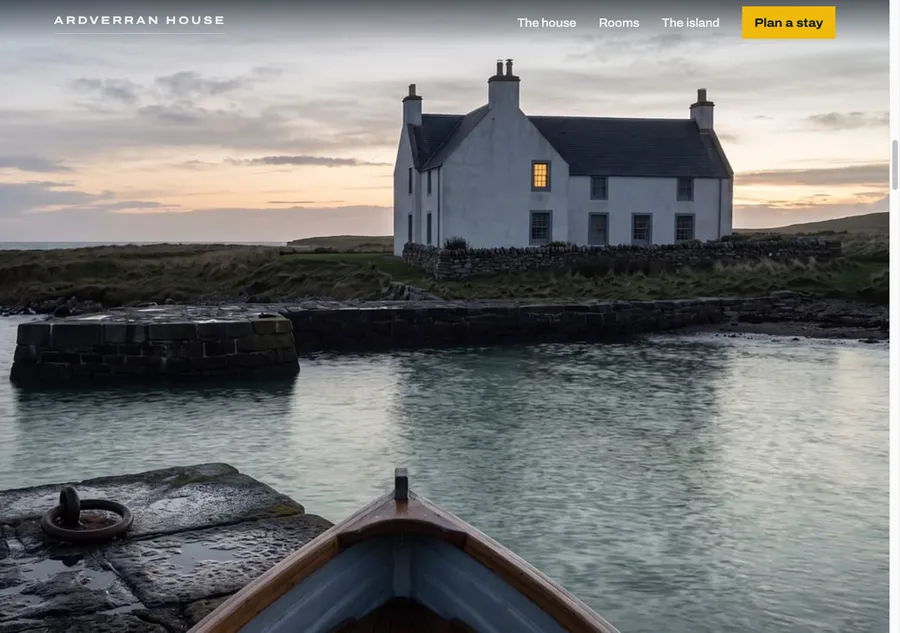 The arrival: the house photographed from the jetty at dusk, one window lit, the boat's bow in the foreground