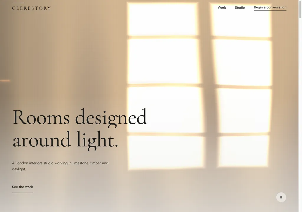 The Clerestory desktop hero at dawn, sheer linen cloth backlit by two tall windows