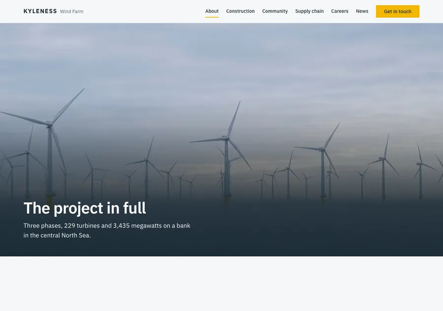 The About window at dawn: rows of turbines soft in the haze beneath the heading The project in full