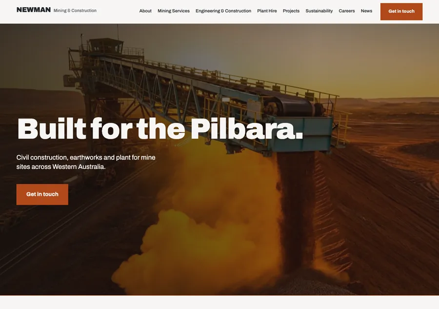The homepage at last light: the stacker discharging onto the stockpile behind the headline Built for the Pilbara