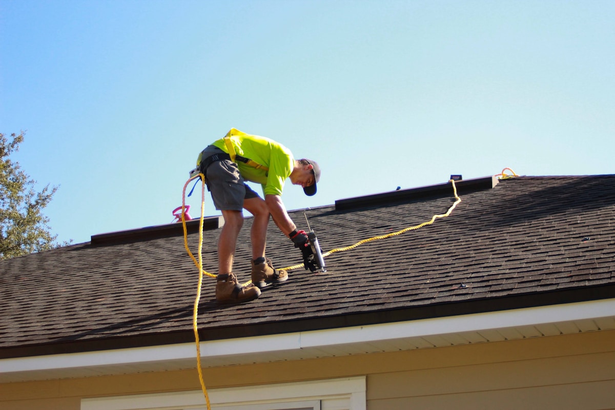 Roofer carrying out roof repair work in Manchester