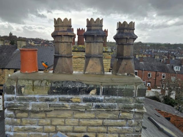 Three ornate crown-pattern chimney pots on a rebuilt stack