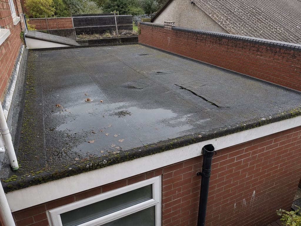 Pre-survey: weathered tile roof on a brick semi